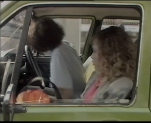 Bond is hidden under a blanket in the back and so Philippa does not see him