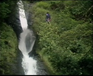 Bond is high up a rock face