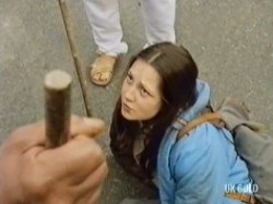 She is knocked to the floor after attacking one the the group