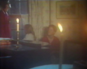 All the lights have gone out so they have to light candles.