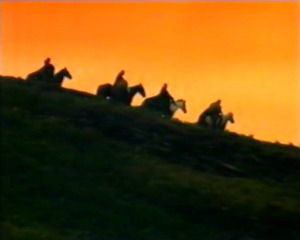 Nia sees four horsemen moving down the hill