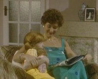 Polly is inside reading with mum - feeling a little left out