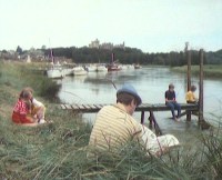The kids are playing near the river