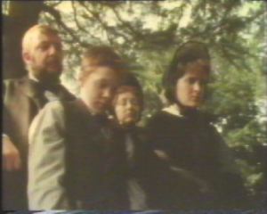 The family all look at the stone