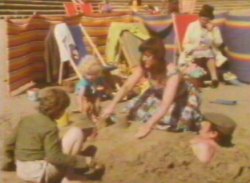 Back on the beach the family are buring dad in the sand