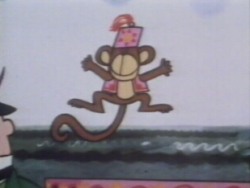 The man has a small monkey doing tricks