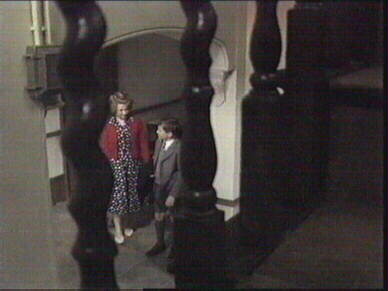 Aunt Gwen and Tom below the staircase