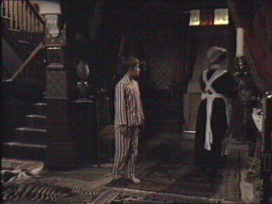 A maid in uniform walks straight past him