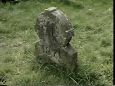 Minty examines the Grave with the initials E L