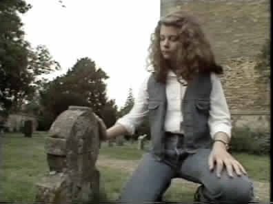 Minty beside the small grave