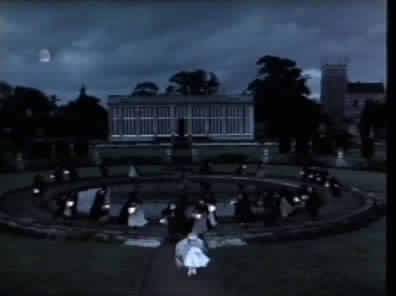 A terrified Sarah is pursued by masked children