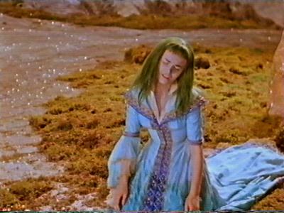 She sobs beside the water